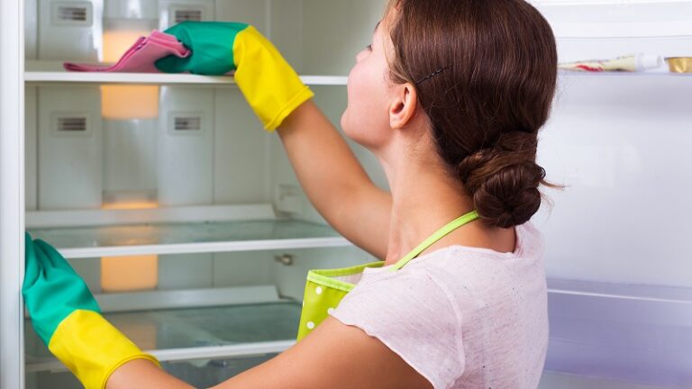 woman cleaning refrigerator